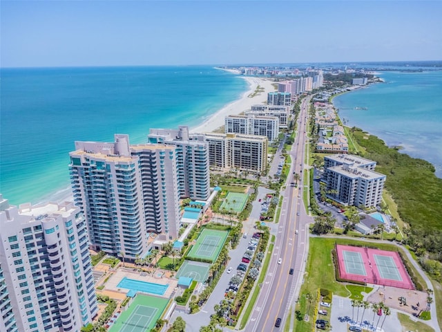 birds eye view of property with a water view and a view of the beach