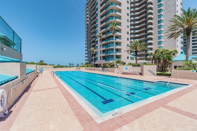 view of swimming pool with a patio