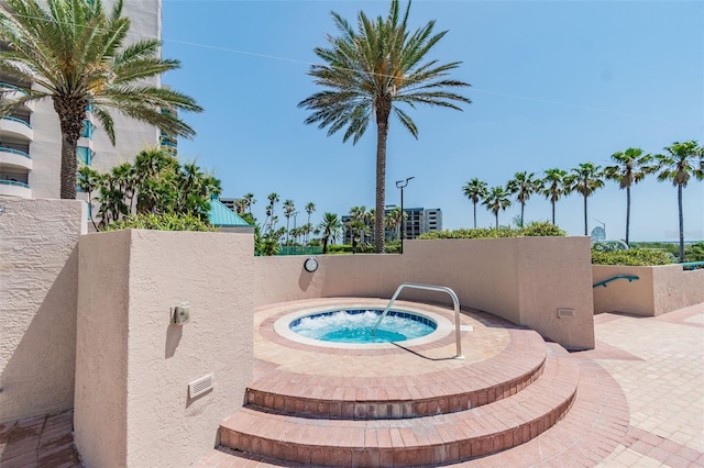 view of swimming pool with an in ground hot tub