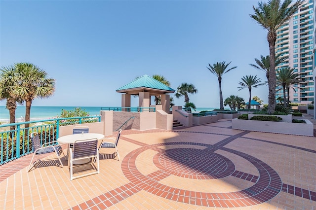 view of patio / terrace with a gazebo and a water view