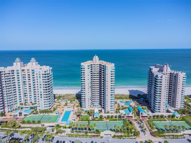 bird's eye view with a water view and a beach view