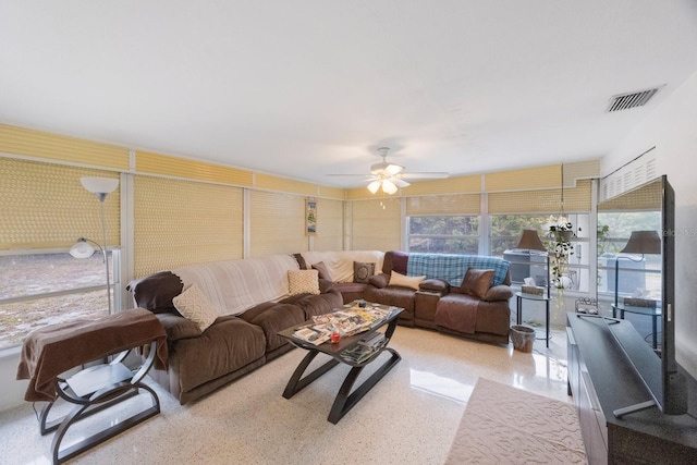 living room with ceiling fan and a healthy amount of sunlight