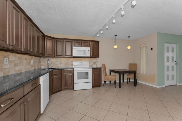 kitchen featuring light tile patterned flooring, pendant lighting, tasteful backsplash, sink, and white appliances