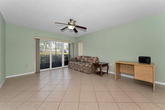 interior space with a textured ceiling and ceiling fan