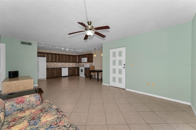 tiled living room featuring a textured ceiling and ceiling fan