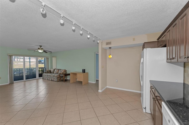 kitchen featuring white appliances, ceiling fan, a textured ceiling, and light tile patterned floors