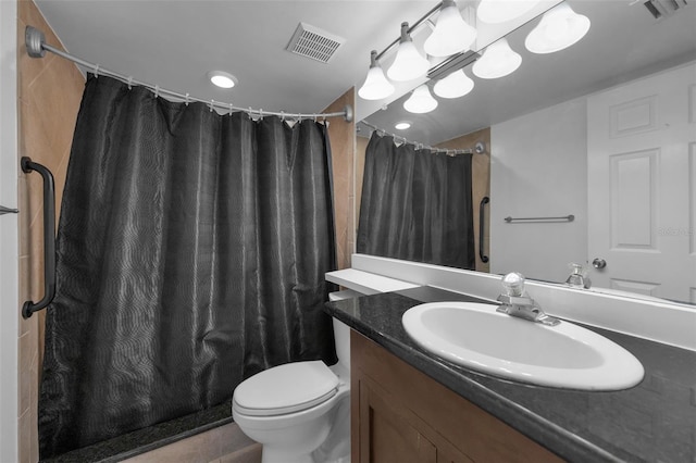 bathroom featuring vanity, curtained shower, and toilet