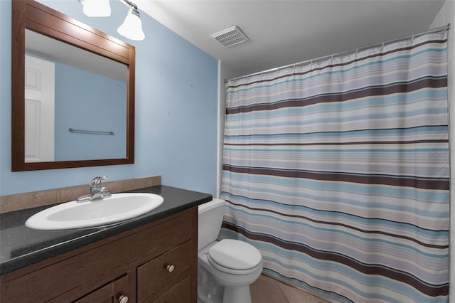 bathroom featuring vanity, a shower with shower curtain, tile patterned floors, and toilet