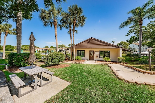 view of property's community with a patio area and a lawn