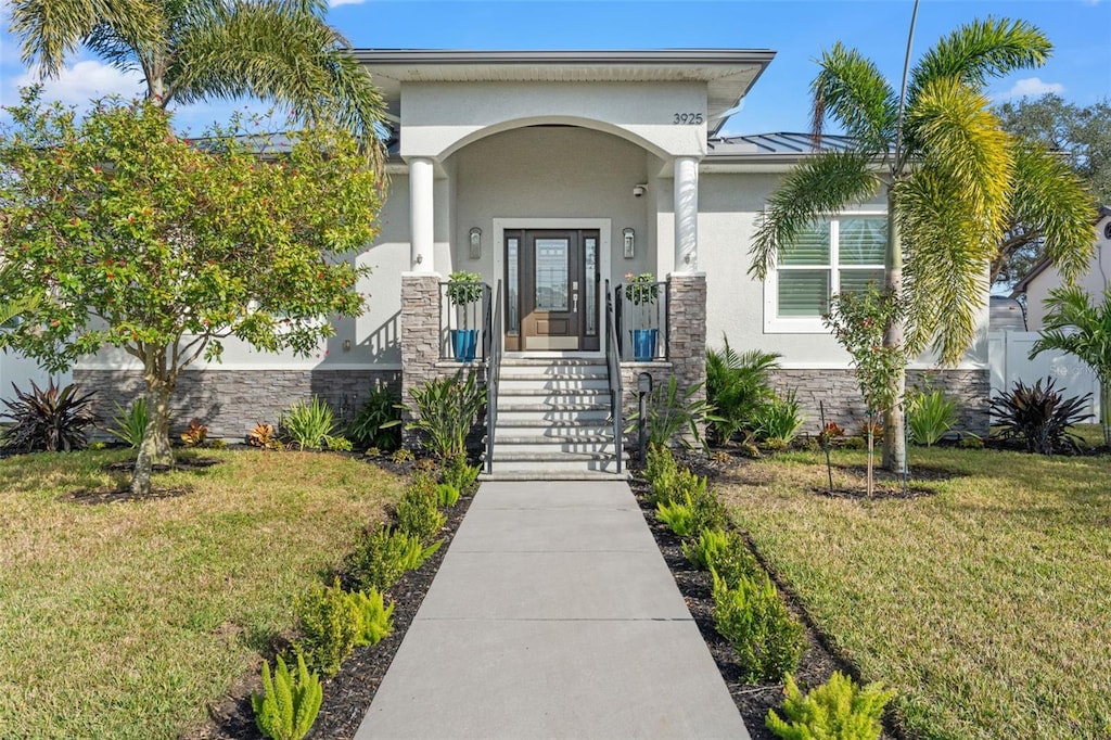 doorway to property with a yard