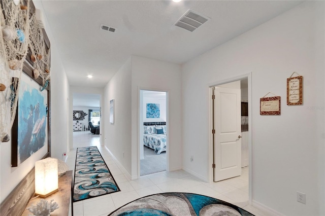 corridor featuring light tile patterned floors