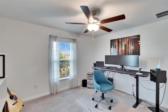 office area with ceiling fan, light colored carpet, and a textured ceiling