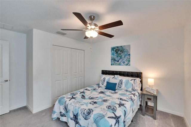 carpeted bedroom featuring ceiling fan and a closet