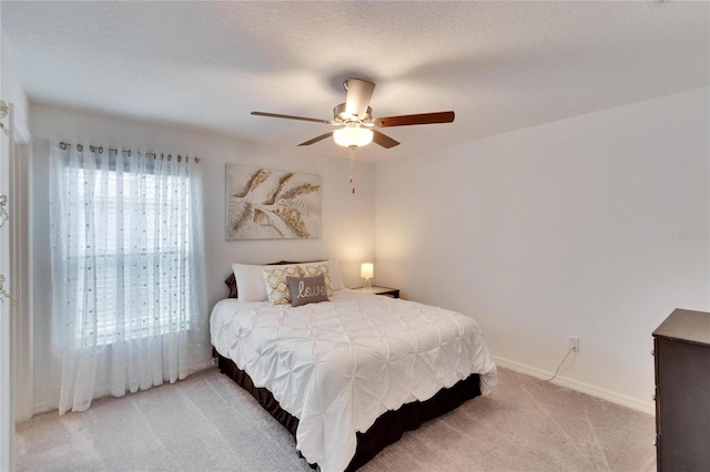 bedroom featuring carpet floors, a textured ceiling, and ceiling fan