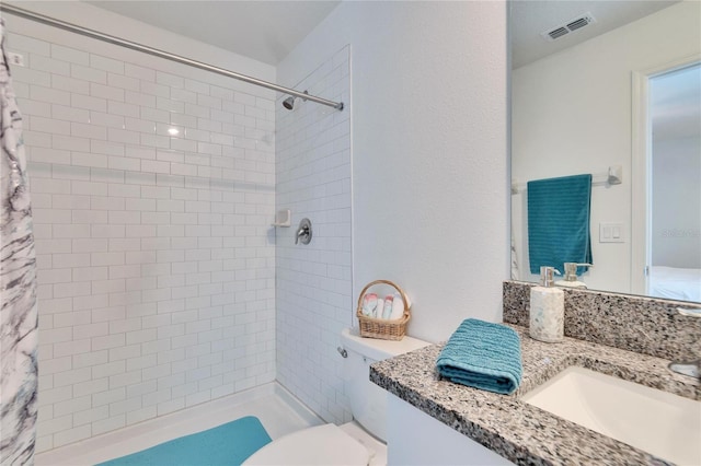 bathroom with vanity, toilet, and curtained shower