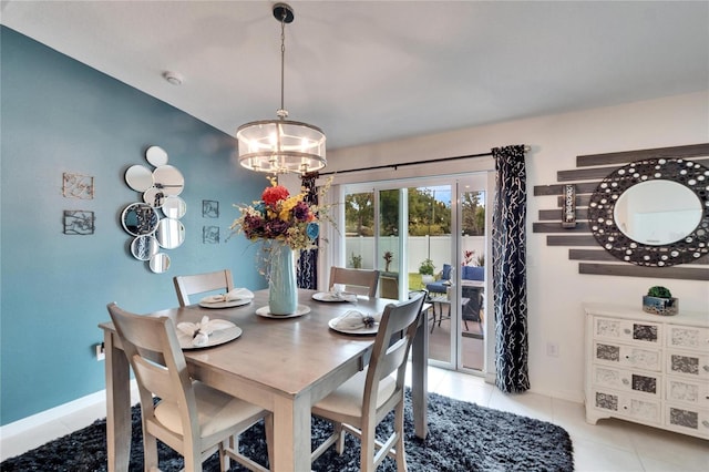 tiled dining room with a notable chandelier