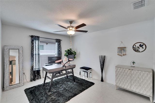 home office featuring light tile patterned floors, a textured ceiling, and ceiling fan