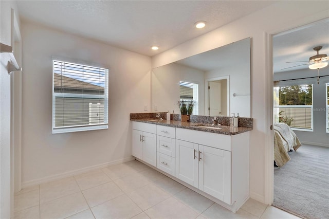 bathroom with vanity, a wealth of natural light, tile patterned floors, and ceiling fan