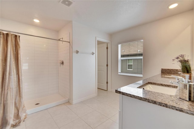 bathroom with a shower with curtain, vanity, and tile patterned flooring