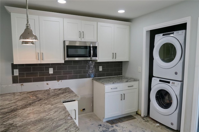 laundry area with stacked washer / drying machine