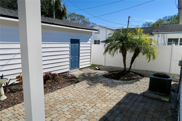 view of patio featuring central AC unit and an outdoor structure