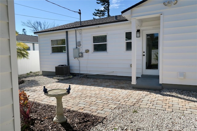 rear view of property with a patio and central air condition unit