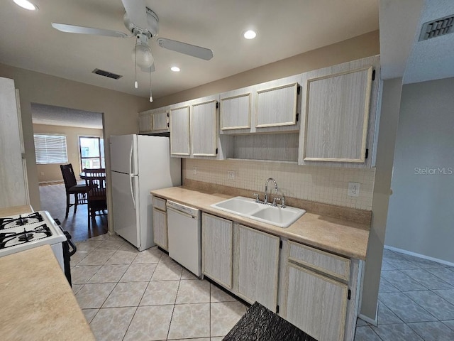 kitchen with sink, decorative backsplash, light tile patterned floors, ceiling fan, and white appliances