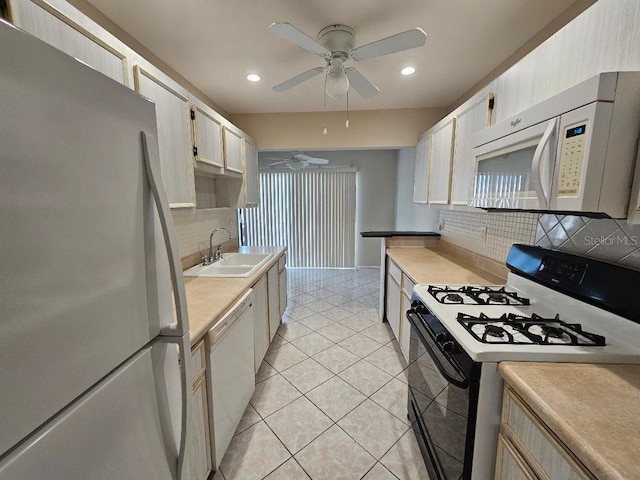 kitchen with light tile patterned flooring, sink, decorative backsplash, ceiling fan, and white appliances