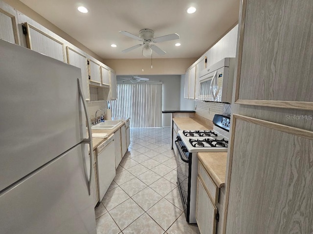 kitchen with ceiling fan, white appliances, sink, and light tile patterned floors