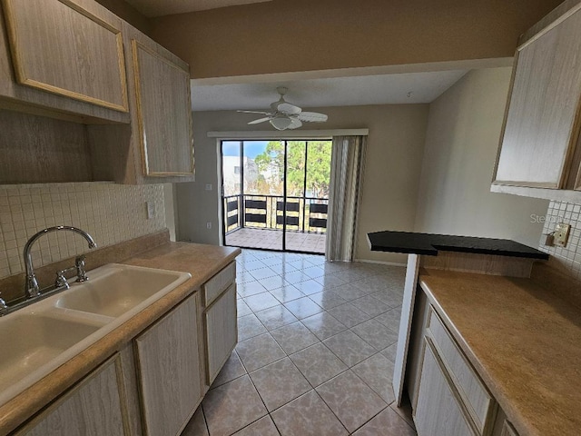 kitchen featuring light brown cabinetry, sink, light tile patterned floors, ceiling fan, and backsplash