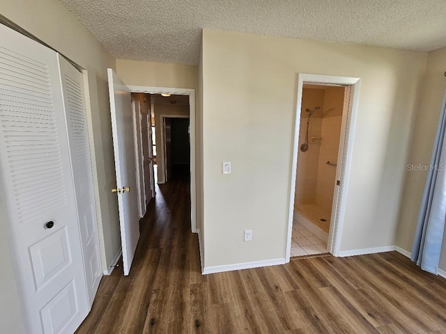 hall featuring dark hardwood / wood-style flooring and a textured ceiling