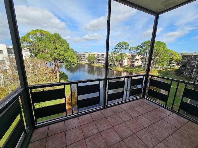 unfurnished sunroom with a water view