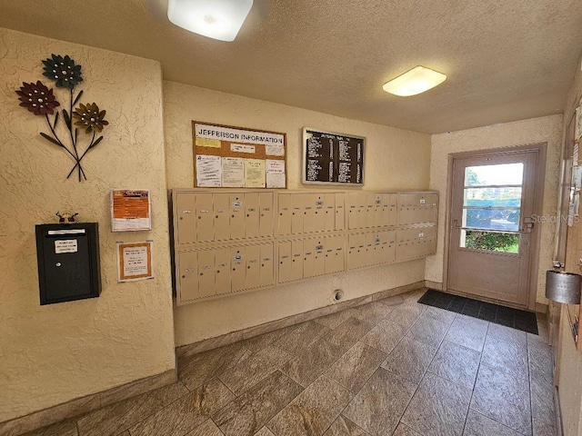 interior space with a textured ceiling and mail boxes