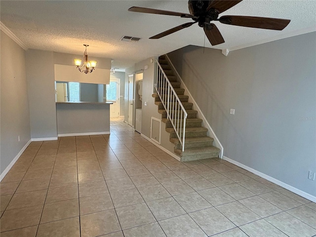 spare room with light tile patterned floors, ceiling fan with notable chandelier, ornamental molding, and a textured ceiling