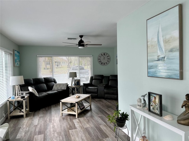 living room with ceiling fan, plenty of natural light, and wood-type flooring