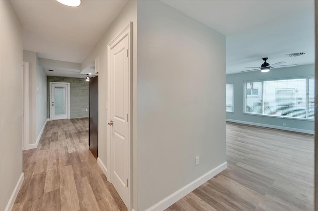 hall with light hardwood / wood-style flooring