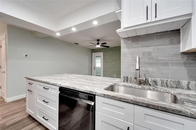 kitchen featuring white cabinetry, dishwasher, sink, and decorative backsplash