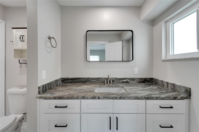 bathroom with vanity and toilet