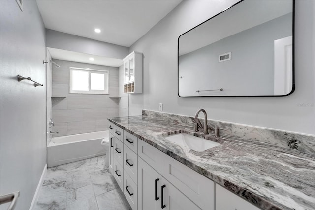 full bathroom with tiled shower / bath combo, vanity, and toilet