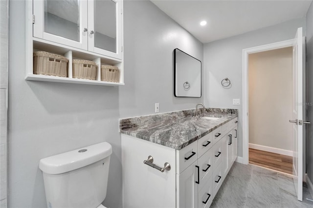 bathroom featuring vanity and toilet