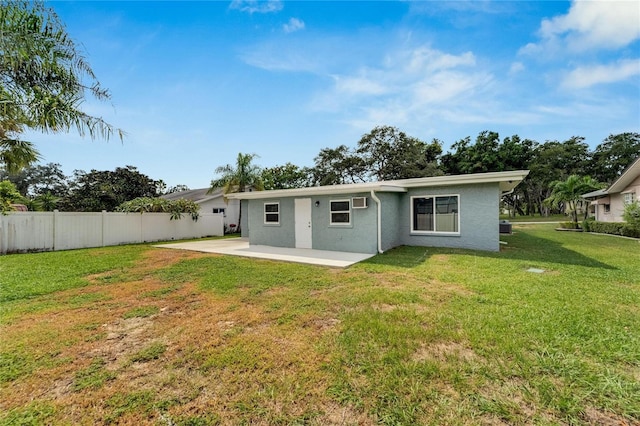 rear view of house with a yard and a patio