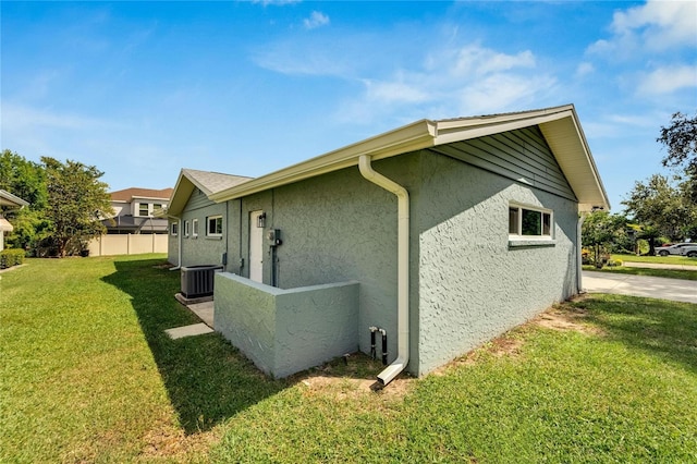 view of home's exterior featuring central AC and a lawn