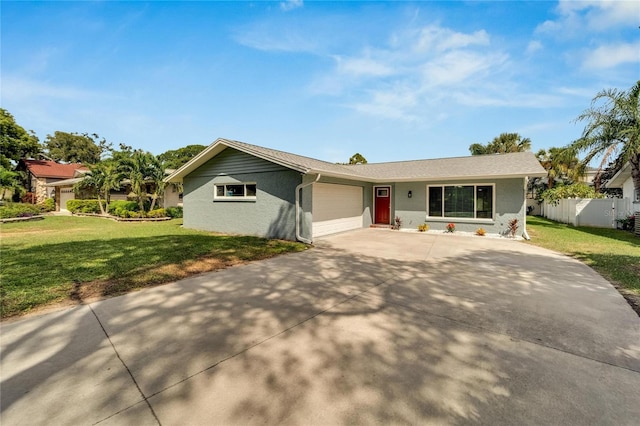 single story home featuring a garage and a front yard