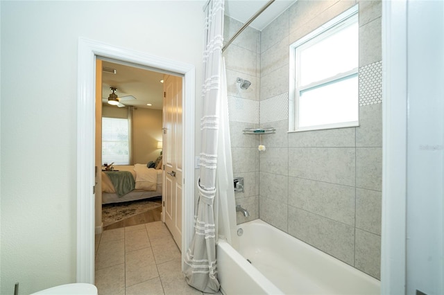 bathroom featuring tile patterned flooring, shower / tub combo, and a wealth of natural light