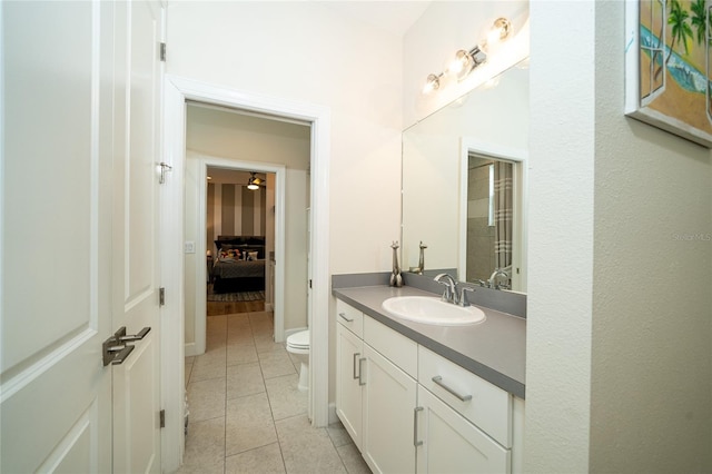 bathroom featuring tile patterned flooring, vanity, and toilet