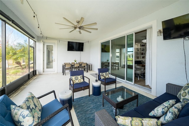 sunroom / solarium with a wealth of natural light and ceiling fan