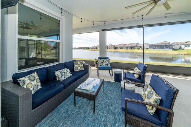 sunroom / solarium with a water view and ceiling fan