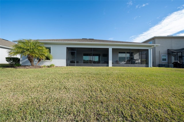 back of house featuring a sunroom and a yard