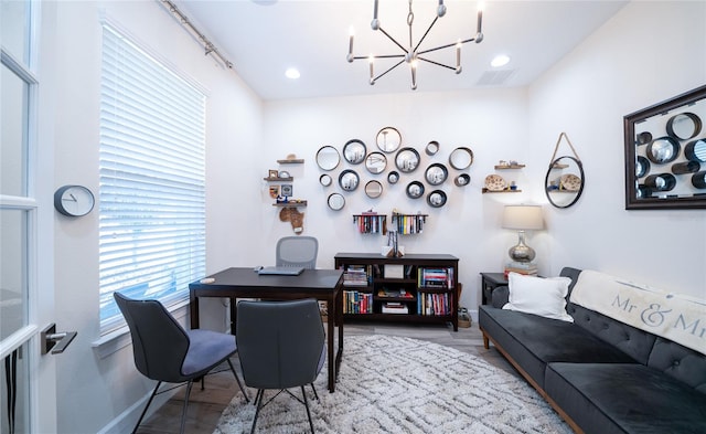 office area featuring an inviting chandelier and light hardwood / wood-style flooring