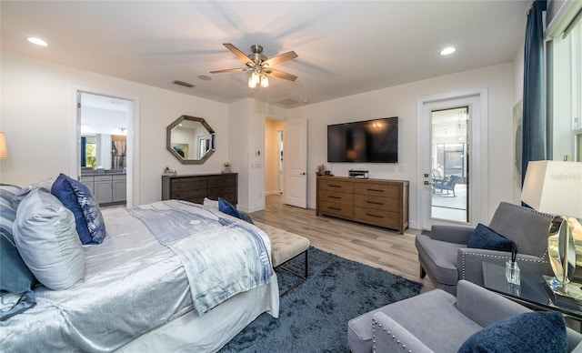 bedroom with ceiling fan, ensuite bath, and light hardwood / wood-style flooring